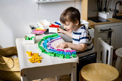 Boy painting on table