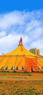 Tent on field against sky