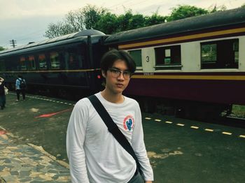 Full length of young man standing on train