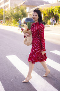 Portrait of young woman holding umbrella