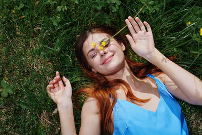 Portrait of smiling young woman sitting on grass