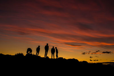 Silhouette of people at sunset