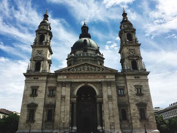 Low angle view of church against cloudy sky
