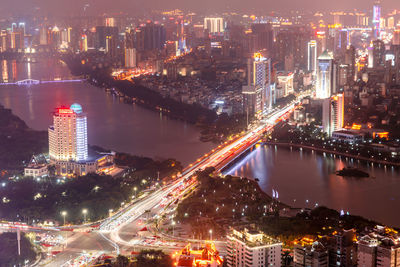 High angle view of illuminated buildings in city at night