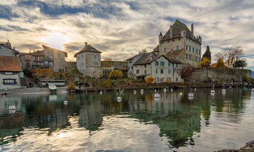 Reflection of buildings in city against sky