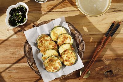 Top view hobak jeon or pan fried zucchini served with soy sauce, sesame seed, and makgeolli