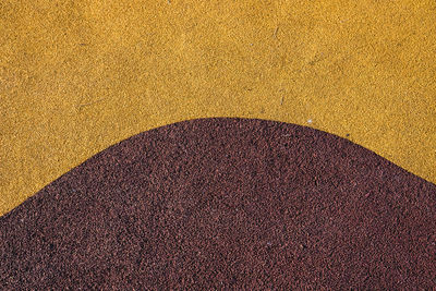 High angle view of yellow shadow on sand