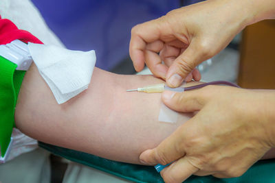 Midsection of doctor examining patient