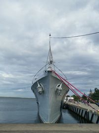 Sailboat on bridge over sea against sky