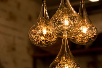 Close-up of illuminated electric bulbs in darkroom