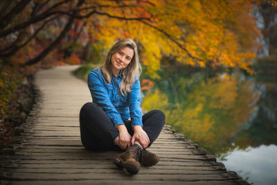 Young woman sitting on pier