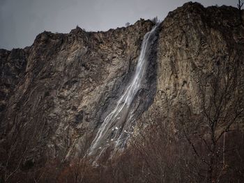 Scenic view of waterfall against sky