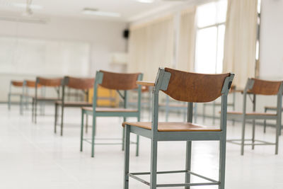 Empty chairs and table in building