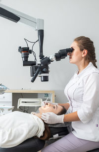 Side view of young man working at clinic