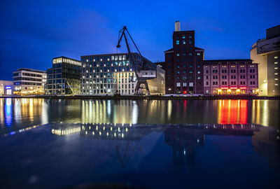 Reflection of buildings in river at night