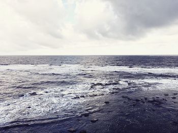 Scenic view of sea against cloudy sky