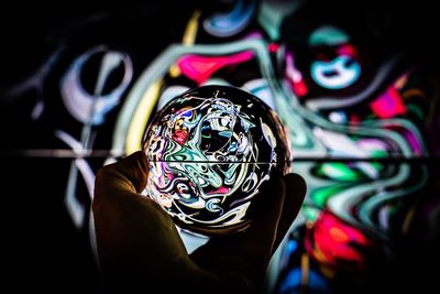 Close-up of person holding illuminated lighting equipment