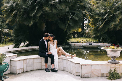 A beautiful couple in love, bride and groom in wedding clothes, walk and pose in the park in nature