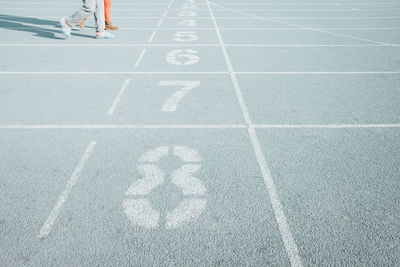 Low section of person running on road