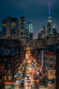 Illuminated city street and buildings at night