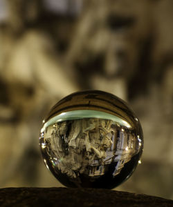 Close-up of crystal ball on glass