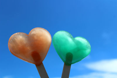 Low angle view of balloons against blue sky