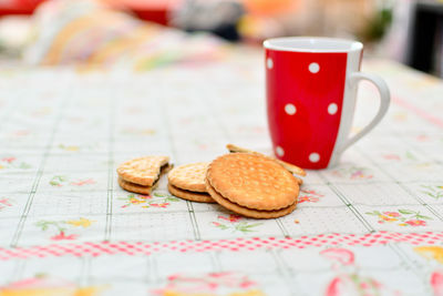 Close-up of coffee with cookies on table