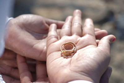 Close-up of hands holding ring