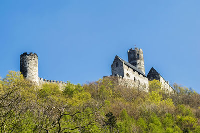 Low angle view of castle against clear blue sky