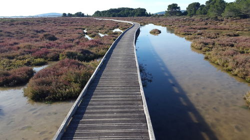 View of empty footpath by river