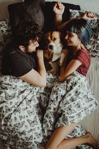 Midsection of couple with dog at home