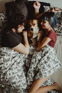 Midsection of woman with dog at home