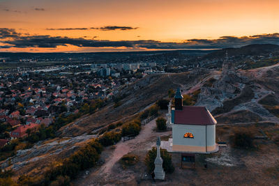 Scenic view of sea and buildings against sky during sunset