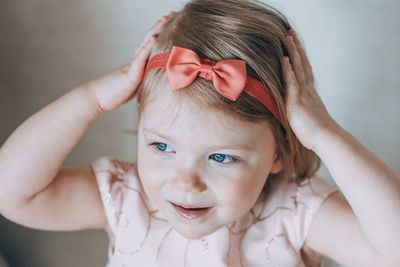 Cute girl wearing headband at home