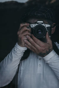 Portrait of mature man photographing at home