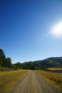 Scenic view of road against clear blue sky