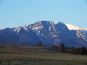 Scenic view of snowcapped mountains against clear sky