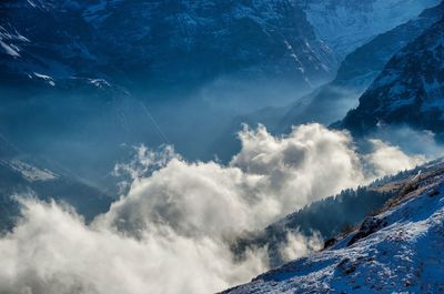 Scenic view of mountains against blue sky