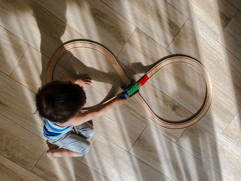 High angle view of boy standing against wall