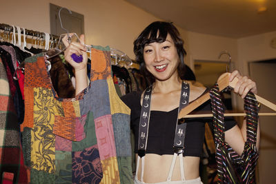 Portrait of smiling young woman standing in store