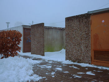 Snow covered buildings against clear sky