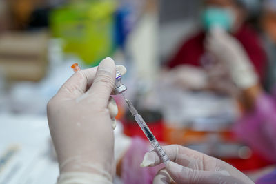 Doctor filling syringe with covid-19 vaccine doctor or scientist in the covid-19 medical vaccine 