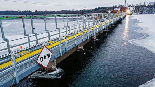 Frozen river with cold walkway at top of the dam.