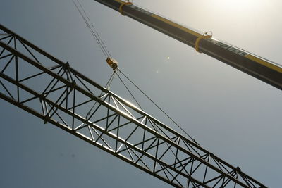 Low angle view of crane against sky