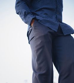 Midsection of man standing against sky