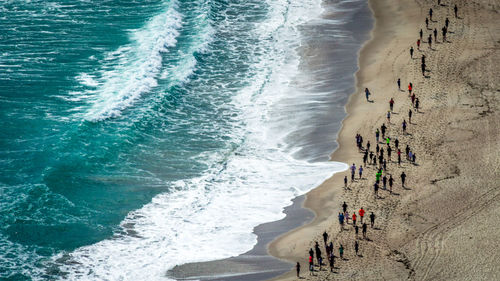 High angle view of people on beach against sky