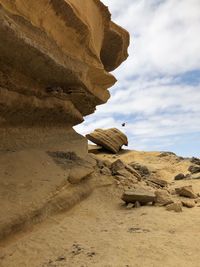 Low angle view of rock formation on desert against sky