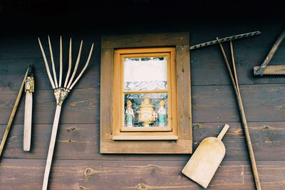 Hand tools hanging on wooden wall