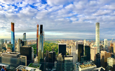 Aerial view of buildings in city against sky