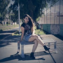 Portrait of young woman sitting outdoors